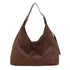 Brown suede hobo bag with silver-toned studs on shoulder strap and small brand logo on lower front