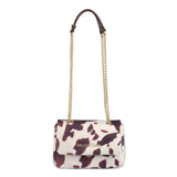 A Valentino Ocarina Winter Flap bag cow med hvit og brun kuprinteffekt i skinn med gulltone hardware og kjedestropp