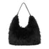 Foxtail handbag black i svart kunstpels med slanke lærstropper og hobo design
